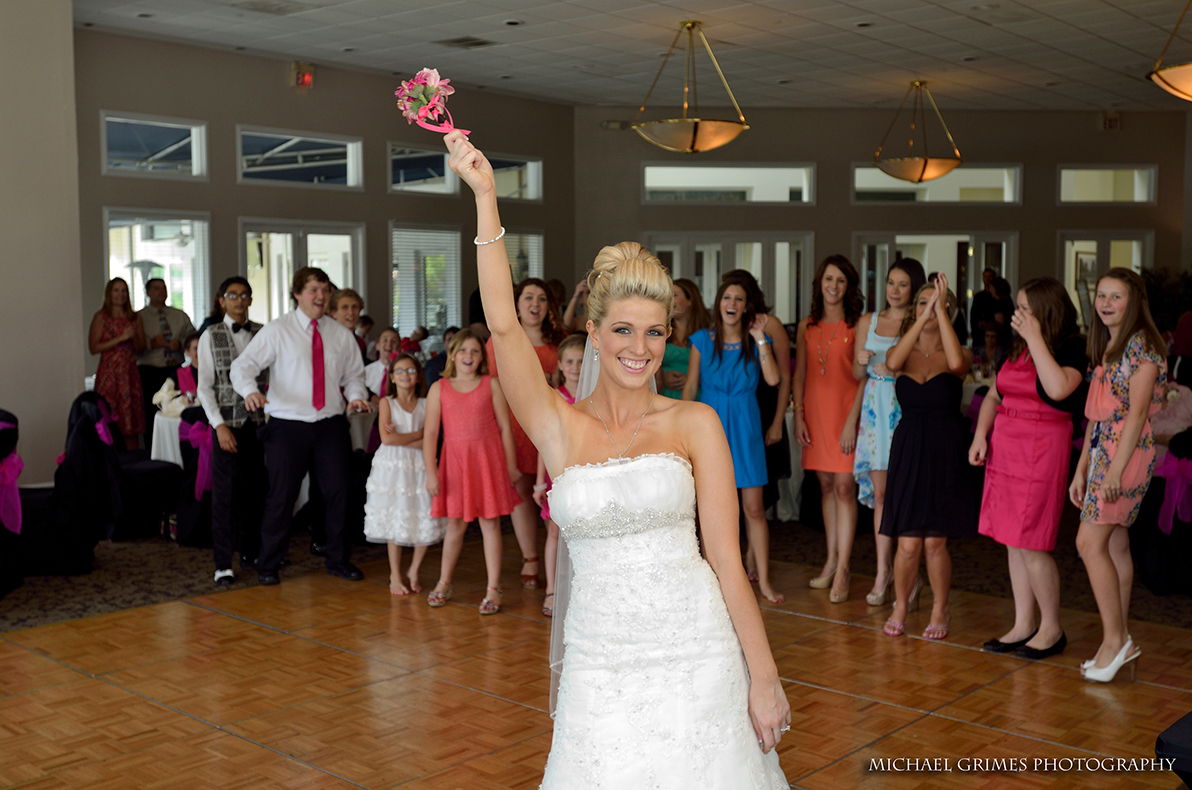 bride holding the bouquet in front of guests